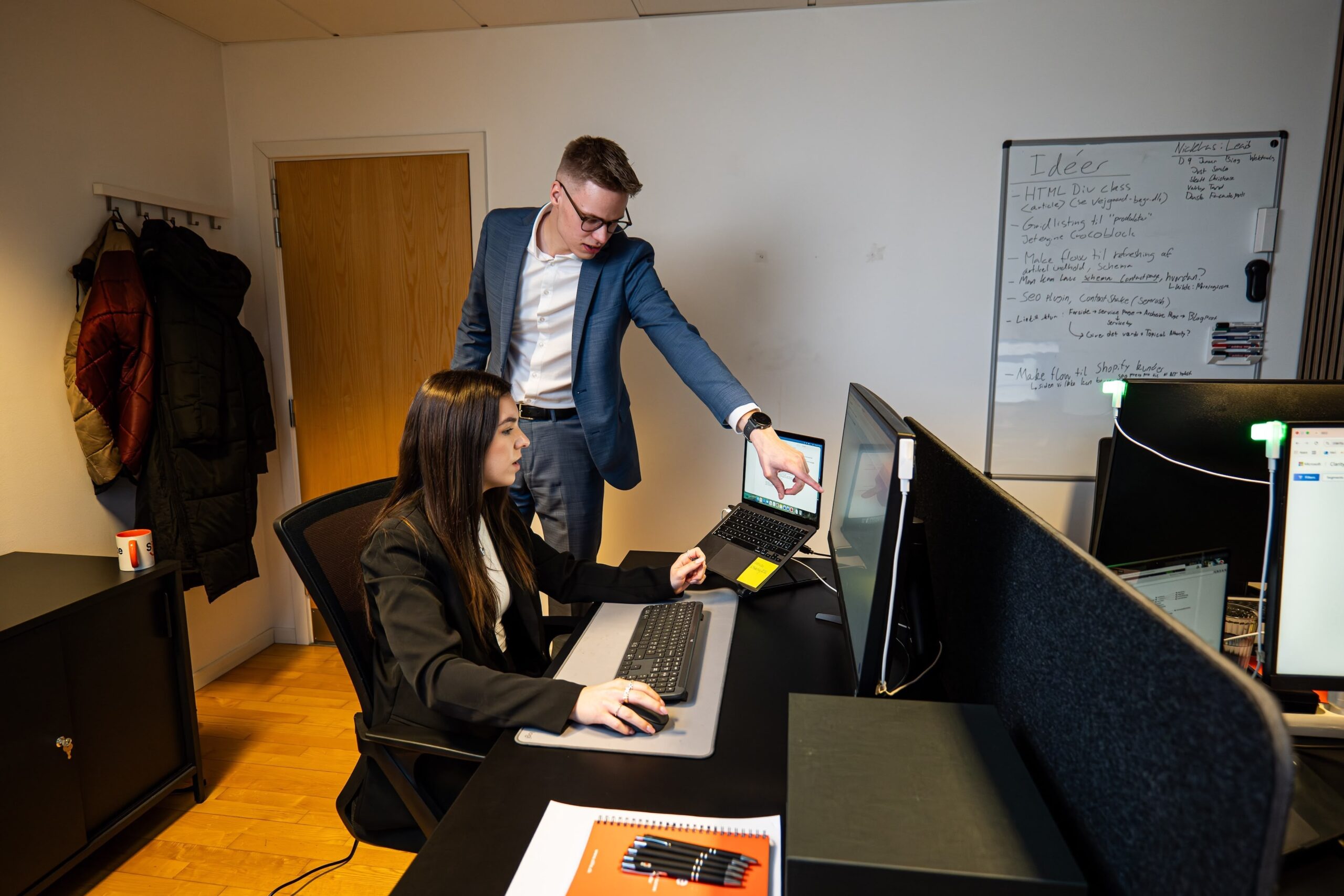 Two team members collaborating at a computer
