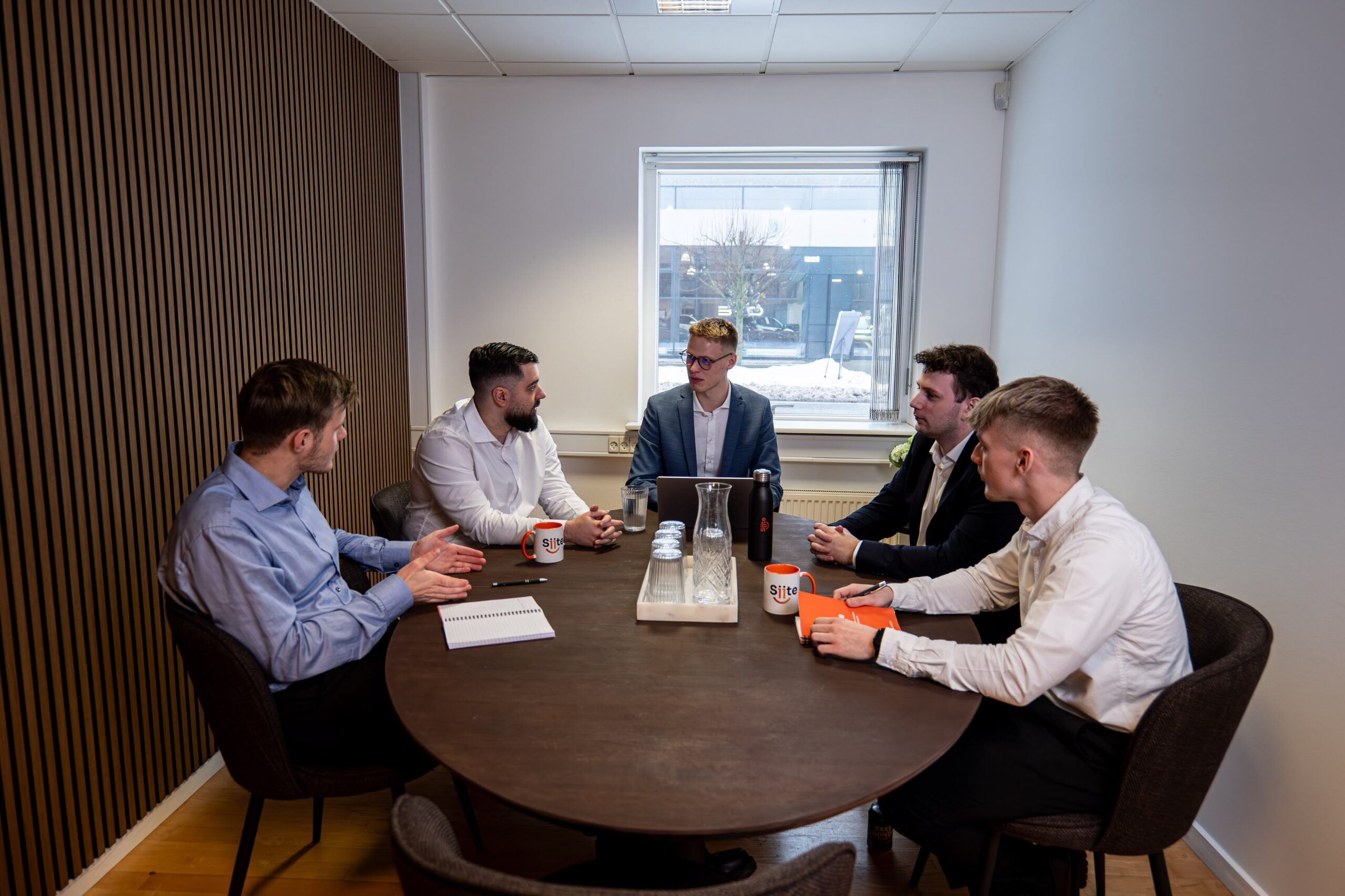 Five people in a strategy meeting